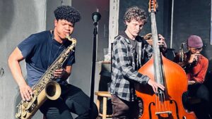 A group of young men playing various musical instruments together.
