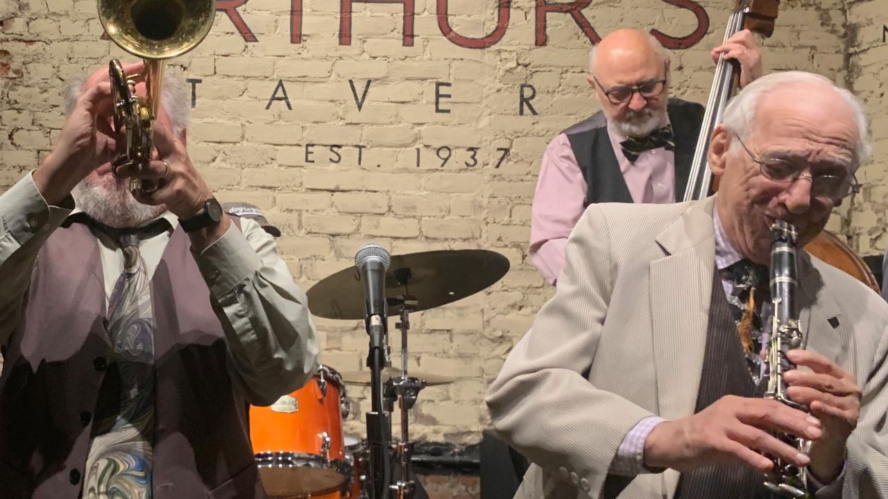 A group of individuals performing music together in a vibrant room atmosphere. 
