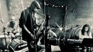 A small jazz ensemble performing live on a cozy stage.