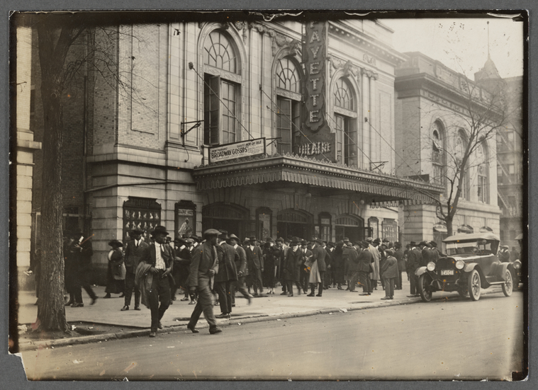 a vintage photo of a group of people walking down the Blvd of Dreams in front of the Lafayette by the Tree of Hope